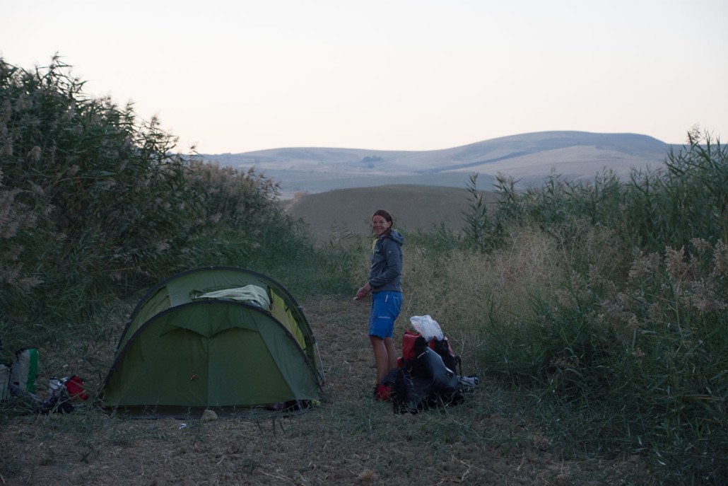 With 115km on the clock, we pitched our tent behind some reeds that shielded us from the road.