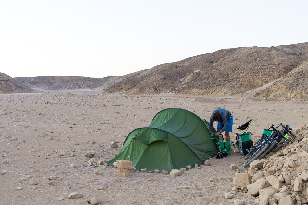 Taking the tent down after enjoying a peaceful night in the desert. Yes, we checked for snakes and scorpions!