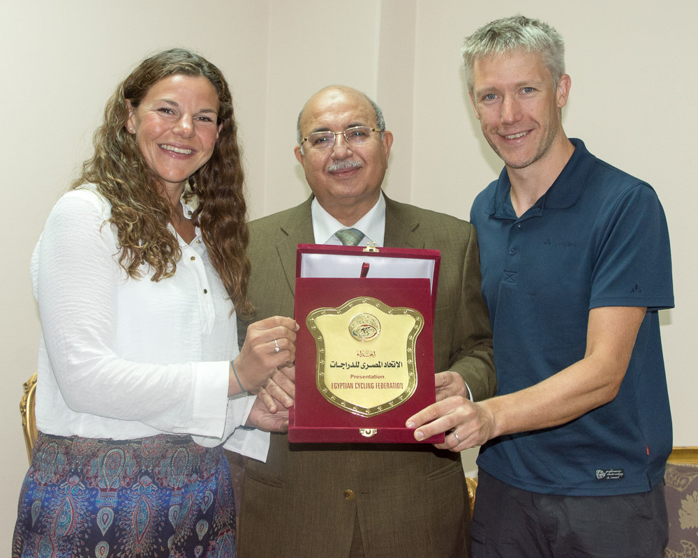 Dr Azzam, the Head of the African Cycling Federation, presents us with an award on behalf of the Egyptian Cycling Federation. I've hidden it in Emily's panniers.