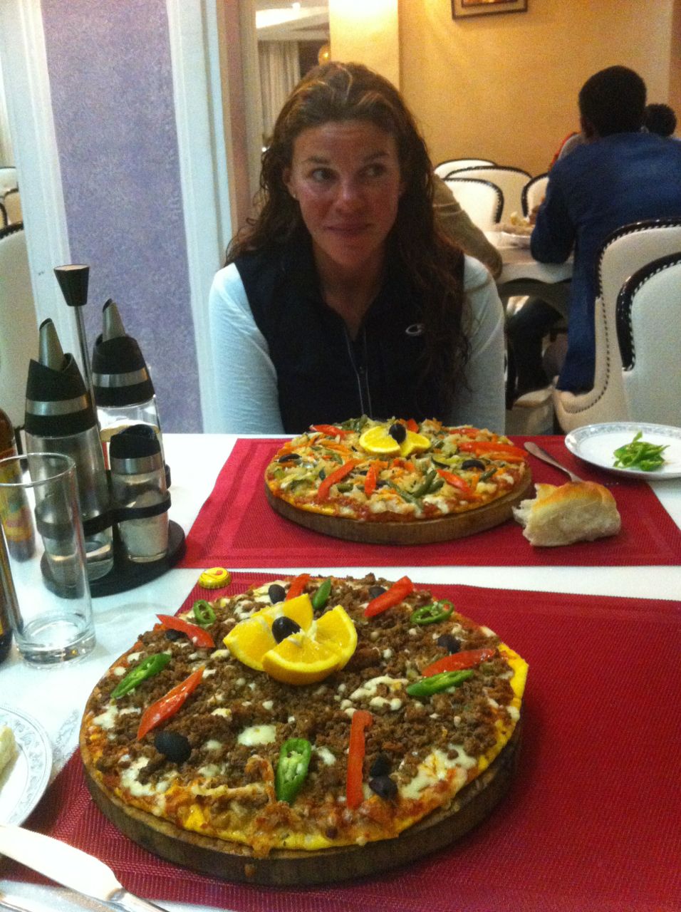 Christmas dinner for us was avery meaty pizza. With orange! (Emily is trying to catch the attention of the waiter!)