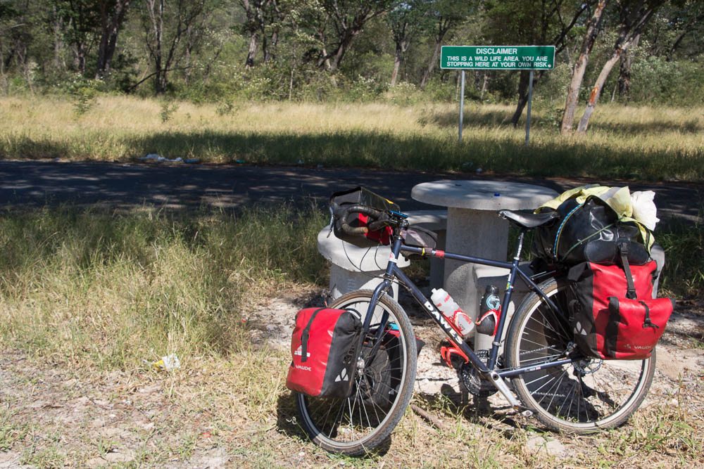 Taking a break with the sign warning of animals behind